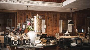 A buffet setup with various food items and condiments on a table, surrounded by wooden paneling and a decorative ceiling.