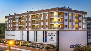 A multi-story hotel with balconies, a sign reading "APARTMENTS CONDADO MARSOL," and a visible outdoor area with plants. - Apartaments Condado (Lloret de Mar)
