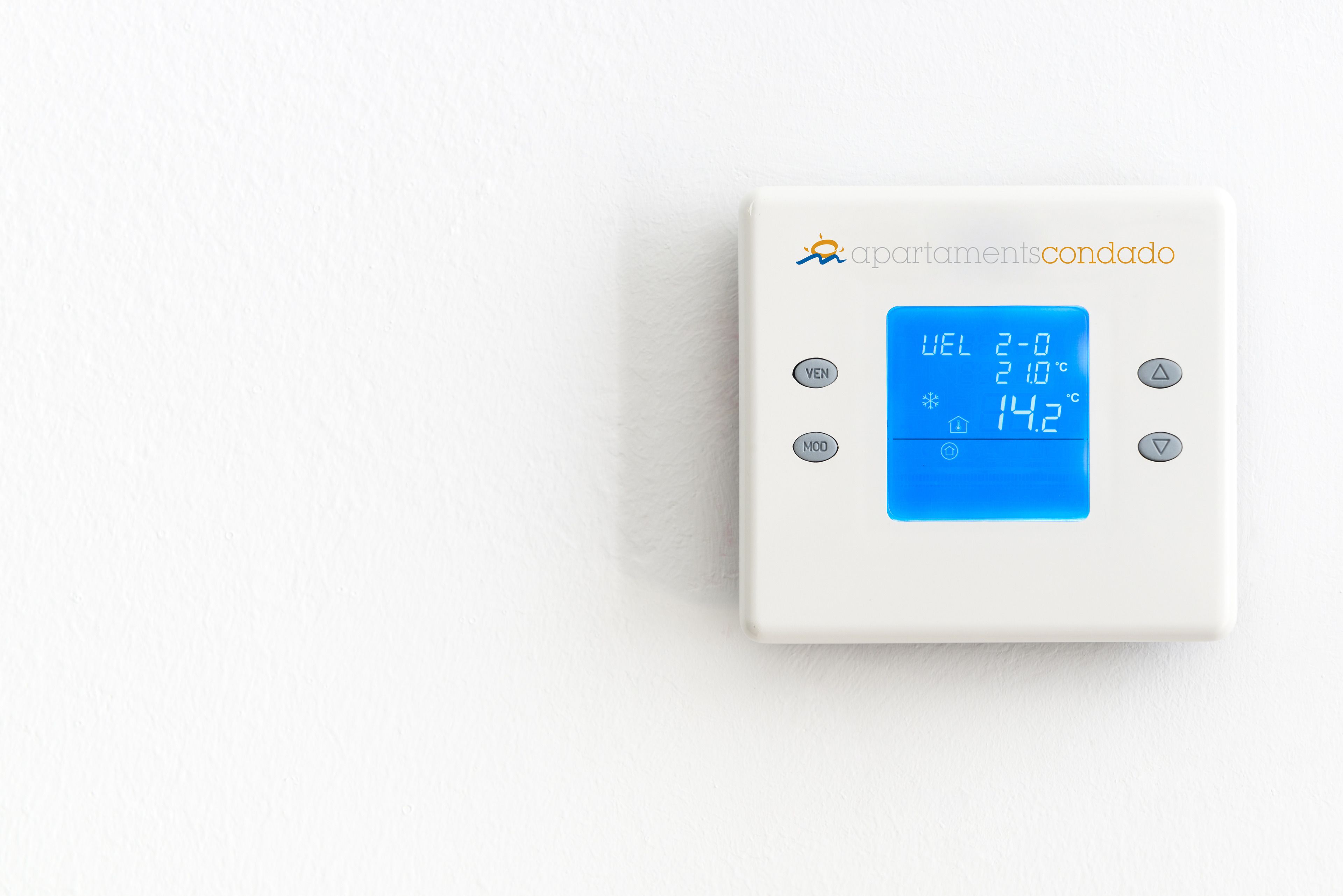 A thermostat with a digital display showing temperature settings.