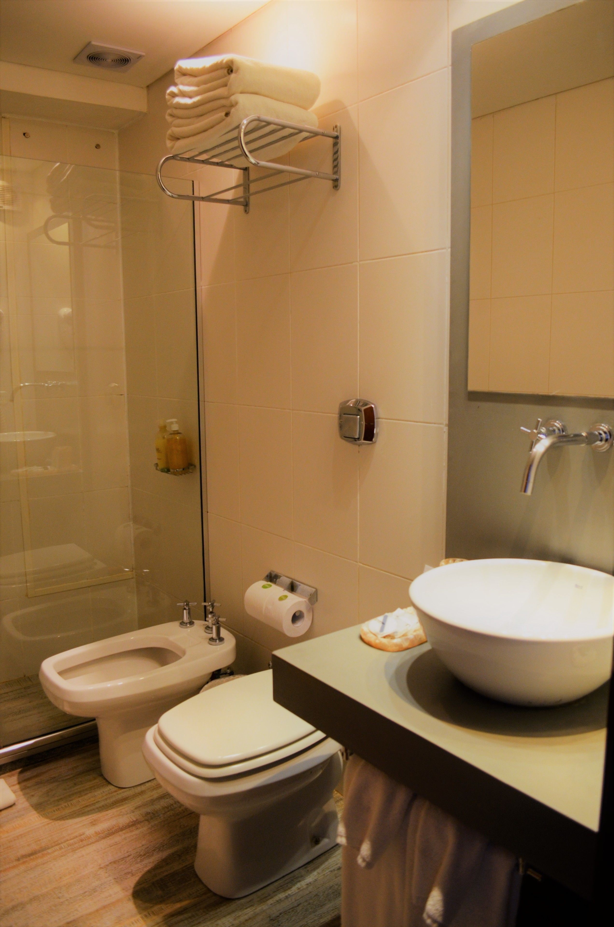 A bathroom with a toilet, bidet, and sink.