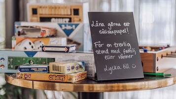 A table with board games and a sign with text in a foreign language.