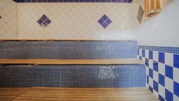 A spa area with a wooden bench, tiled walls, and a checkered pattern on the right.