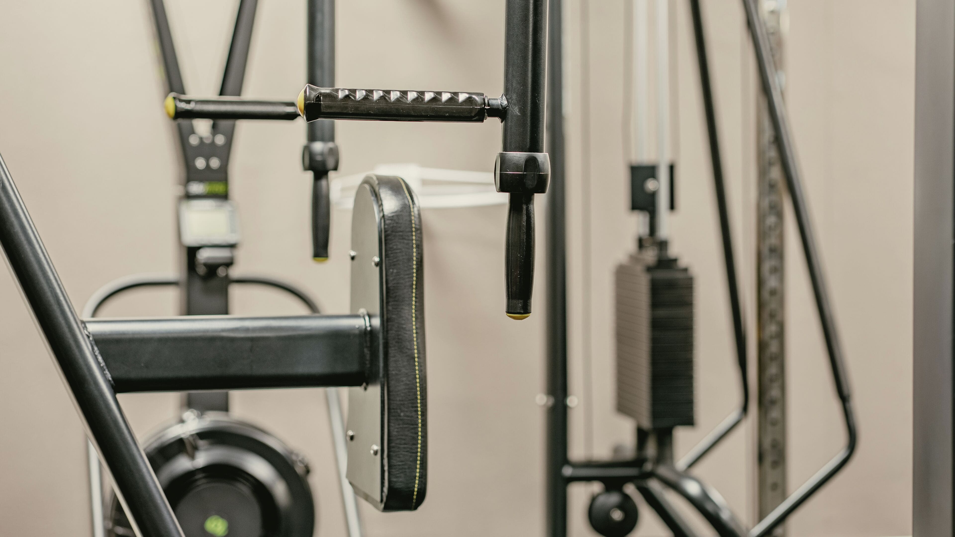 A gym with exercise equipment, including a cable machine and weight stack.