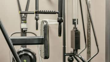 A gym with exercise equipment, including a cable machine and weight stack.