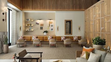 A modern living room with a sofa set, a coffee table, and a fireplace.