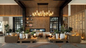 Un vestíbulo moderno con chimenea, zona de estar e iluminación decorativa.