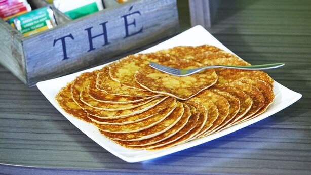 A plate of pancakes with a spoon on a table. - Hotel Kyriad Reims Est Parc des Expositions (Reims)