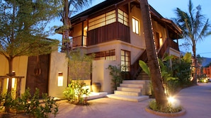 A two-story building with a balcony, steps leading to the entrance, and a well-lit pathway. - Buri Rasa Village Samui Adults Only (Koh Samui)