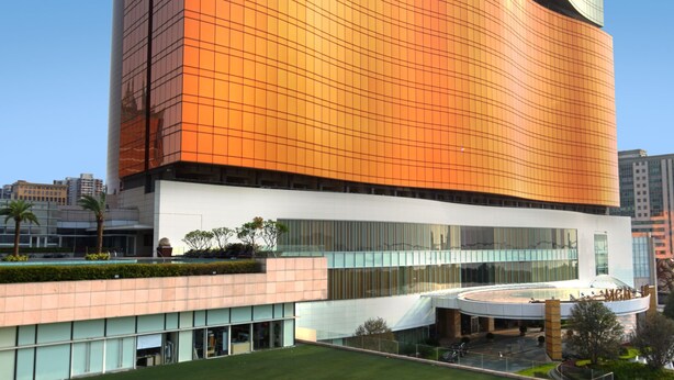 A multi-story building with a distinctive architectural design, featuring a mix of reflective and matte surfaces. - MGM MACAU (Macau)