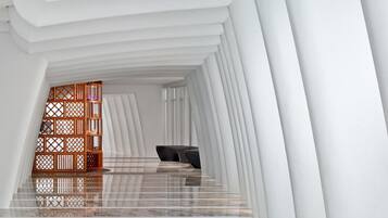 A modern interior with a curved ceiling and a reflective floor.