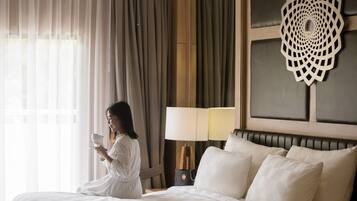 Une chambre d’hôtel avec un grand lit, une table de chevet avec une lampe et un élément décoratif mural.