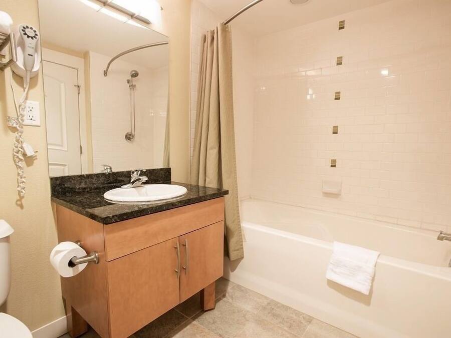 A bathroom with a sink, toilet, and shower.