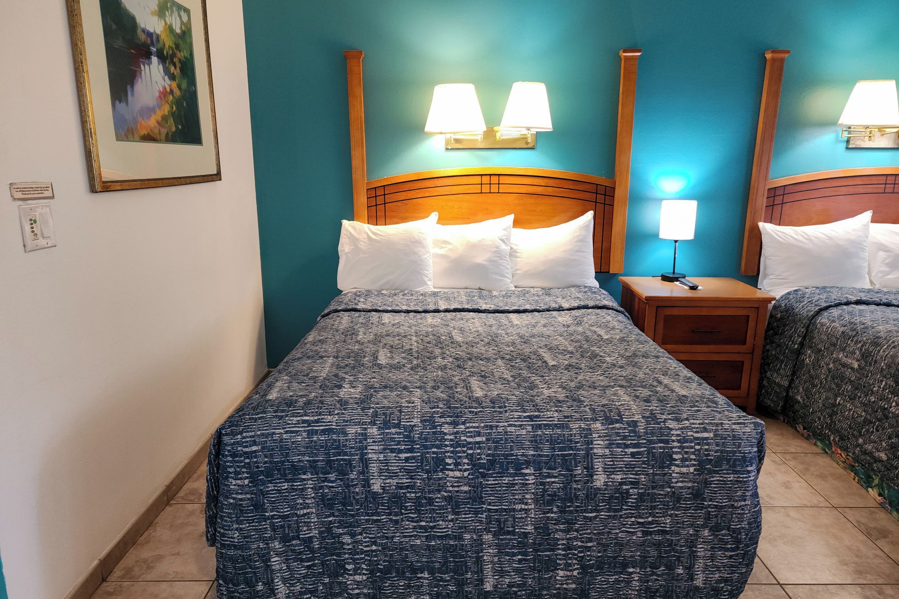 room, 2 queen beds, refrigerator & microwave, courtyard area | blackout curtains, iron/ironing board, free wifi, bed sheets
