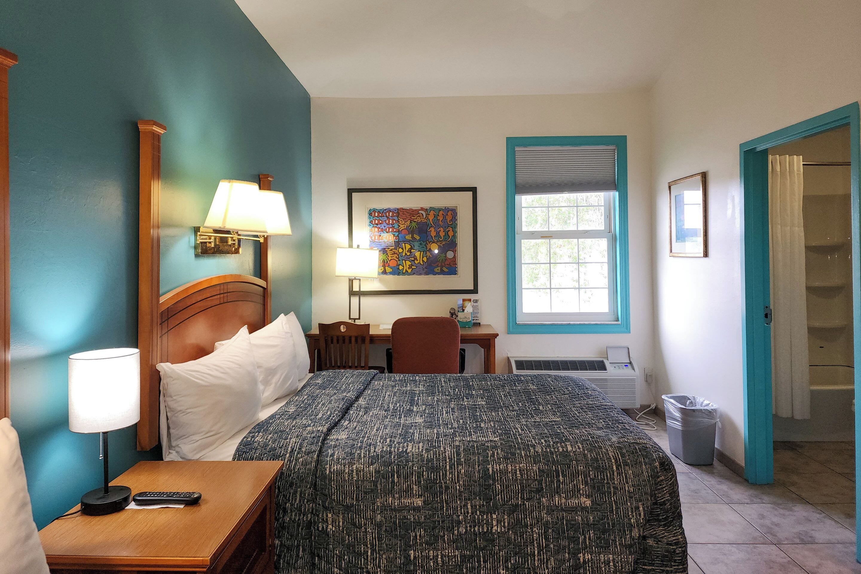 room, 2 queen beds, refrigerator & microwave, courtyard area | blackout curtains, iron/ironing board, free wifi, bed sheets