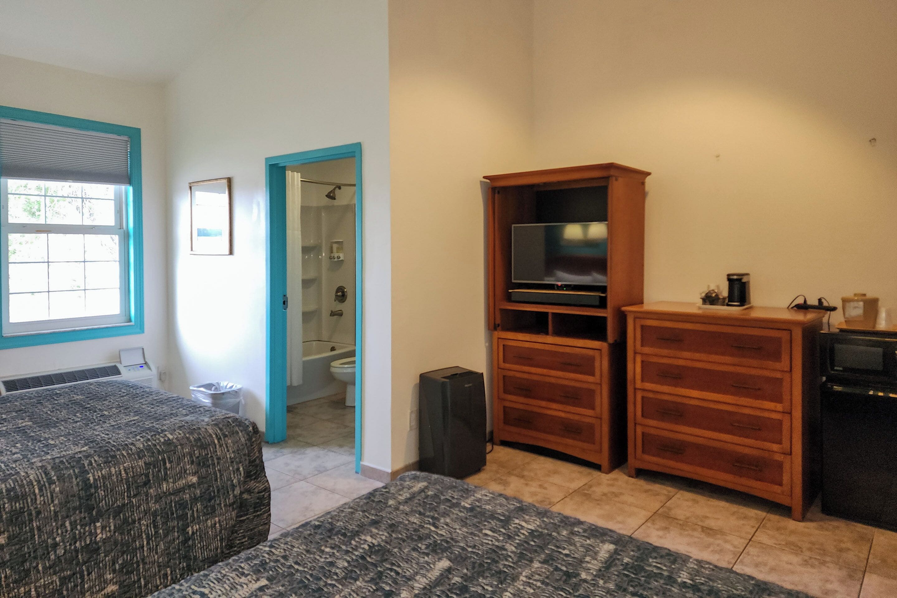 room, 2 queen beds, refrigerator & microwave, courtyard area | blackout curtains, iron/ironing board, free wifi, bed sheets