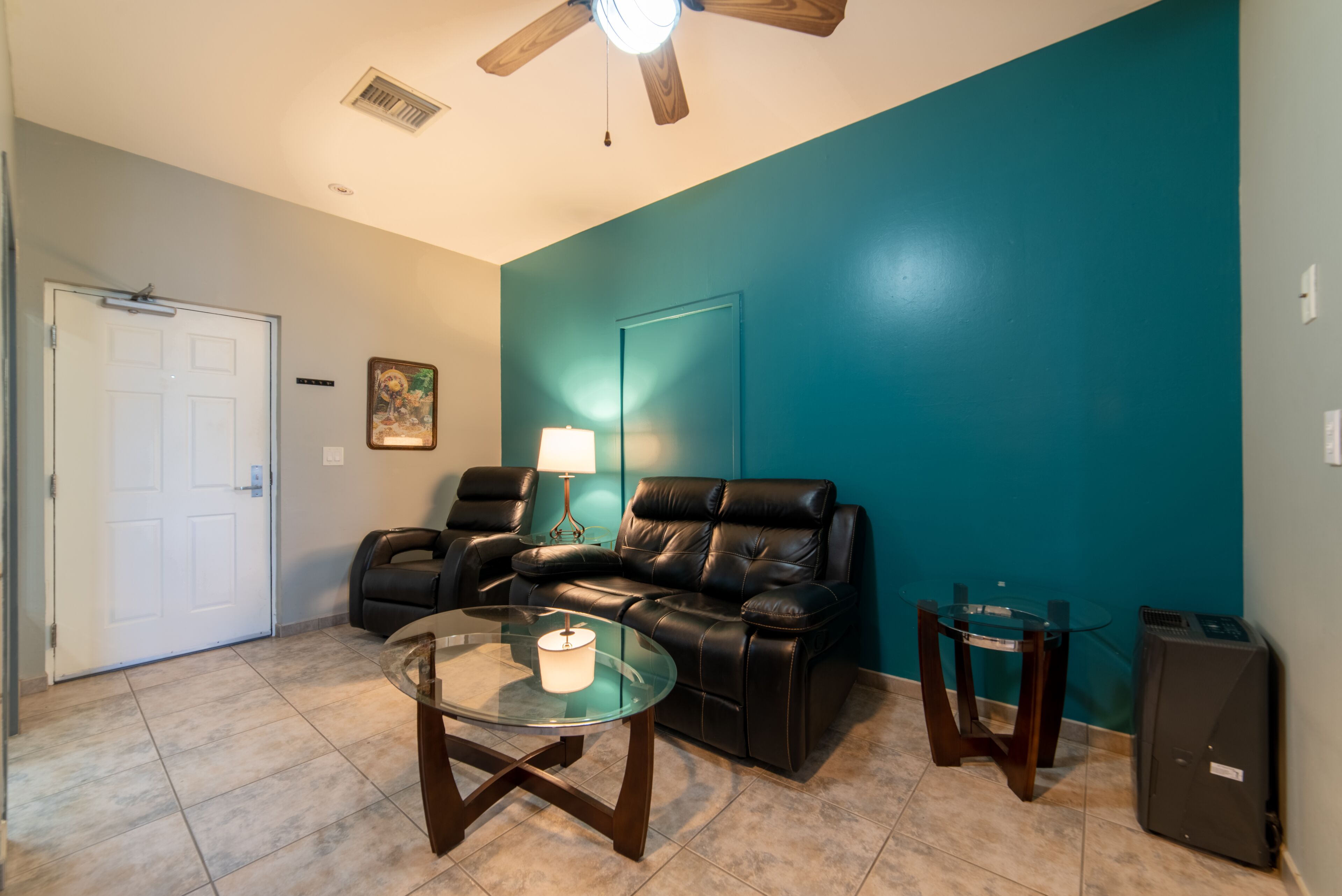 deluxe room, 2 queen beds, refrigerator & microwave | living area | 24-inch tv with cable channels