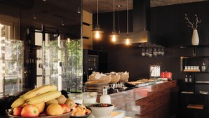 A modern kitchen with a fruit bowl, a coffee machine, and a buffet counter.