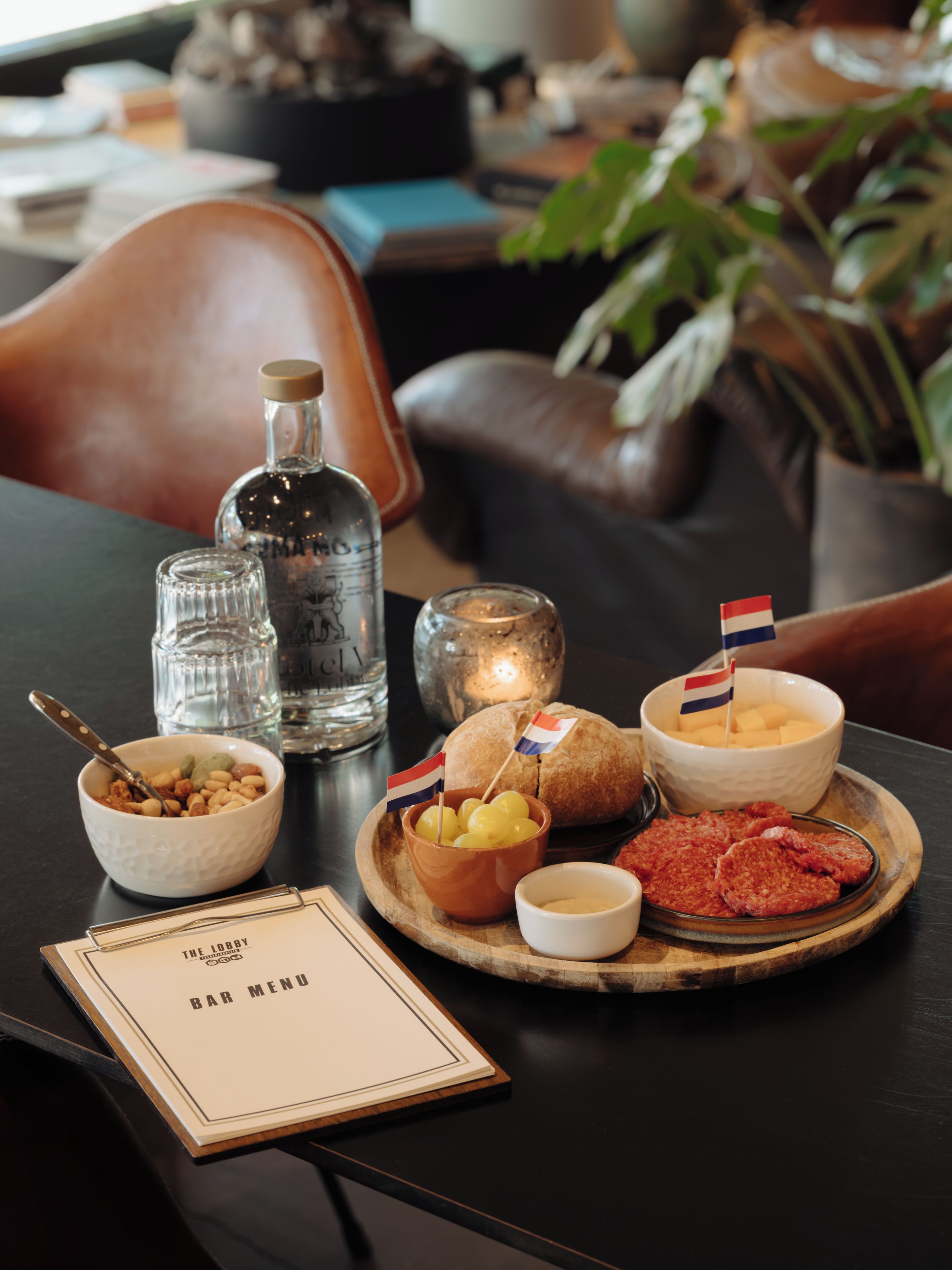 A bar menu with a selection of food items including bread, cheese, and meat.