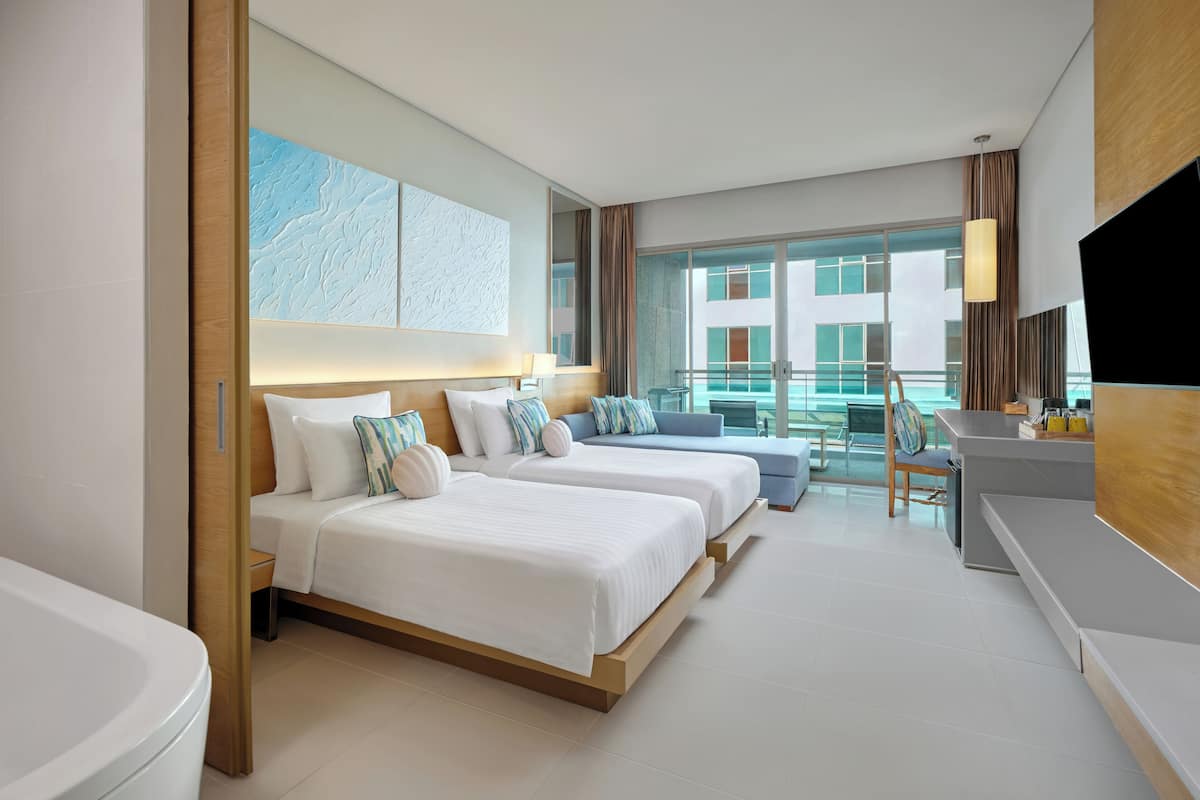 A modern hotel room with two beds, a large window with a view, a balcony, and a TV.