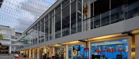 Un edificio moderno con grandes ventanales y un escaparate con un letrero azul que dice