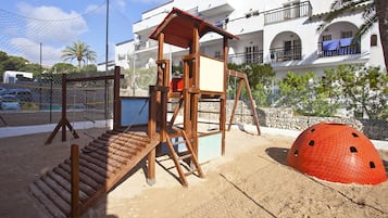 Children can play and climb in this outdoor play area with a wooden structure and enclosed playhouse.