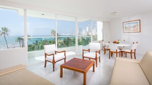 A spacious living room with a large balcony, white furniture, and a city view. - Hotel Dann Cartagena (Cartagena)