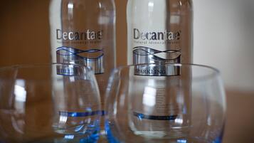 Two bottles of Decantae sparkling mineral water with labels and a blue design element.