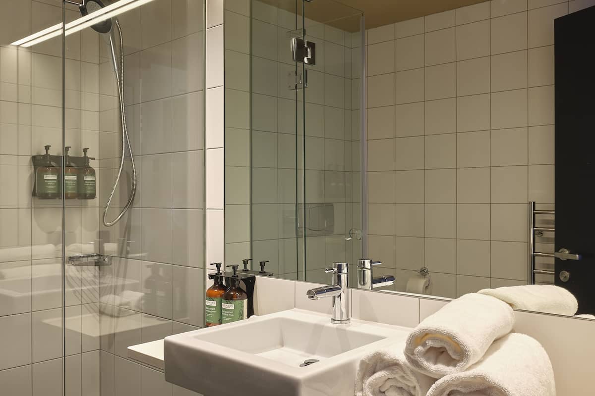 shower, hair dryer, towels, soap