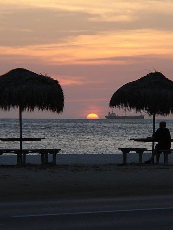 On the beach, white sand, sun loungers, beach towels