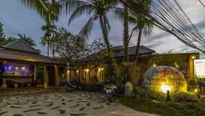 A beachfront resort with a bar, a sign for 'Bangtao Beach Resort', and a motorcycle parked in front. - Bangtao Beach Chalet (Choeng Thale)