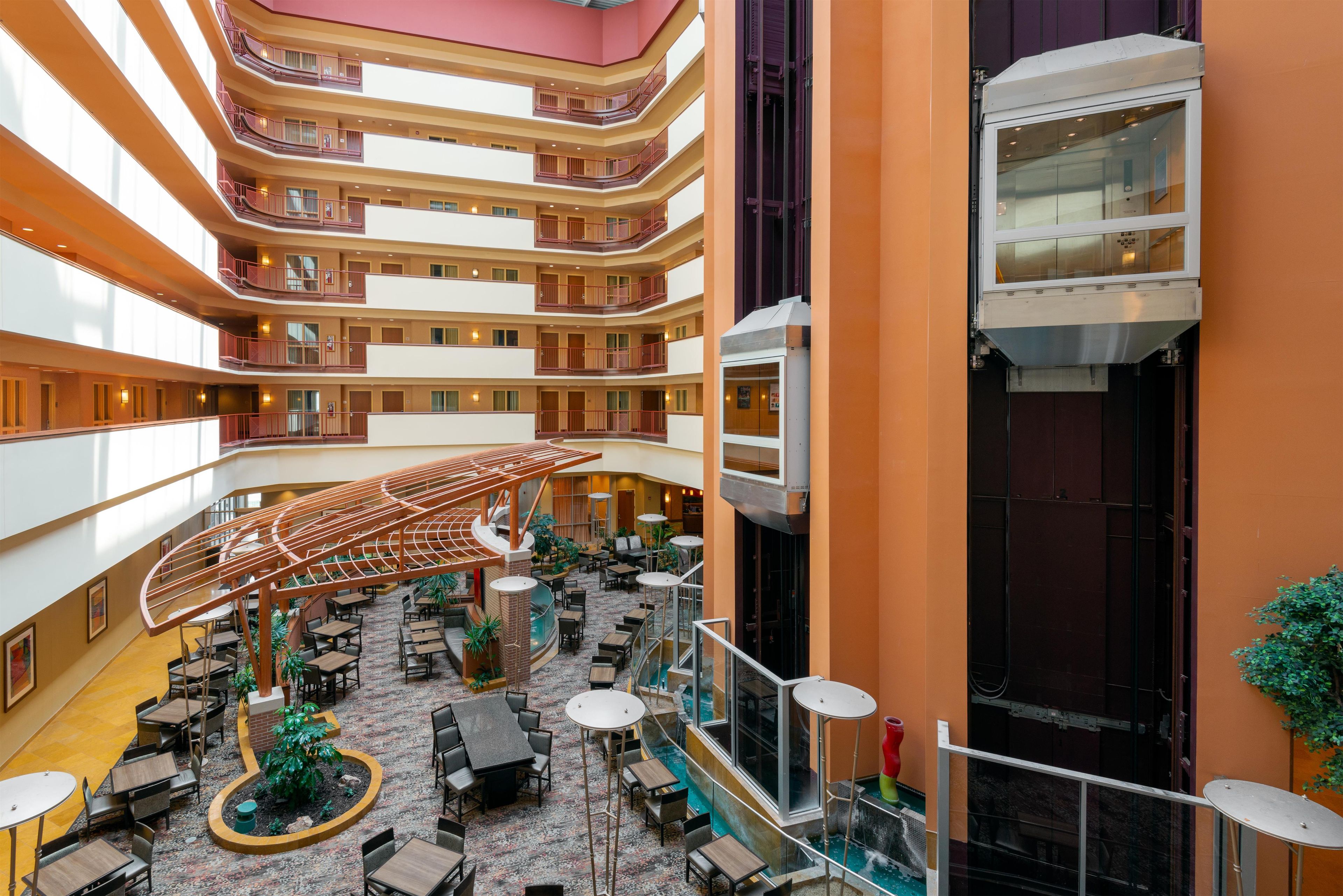 A multi-level atrium with a central open space, multiple floors, and a variety of seating arrangements.