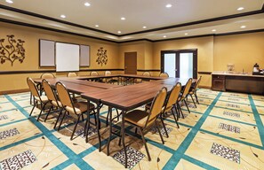 A conference room with a large table, chairs, a whiteboard, and a door. - Holiday Inn Express Hotel & Suites Victoria by IHG (Victoria)