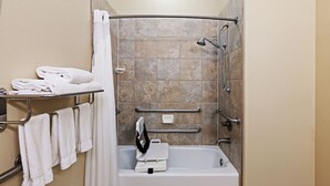 A bathroom with a bathtub, grab bars, a towel rack, and a shower curtain. - Holiday Inn Express Hotel & Suites Victoria by IHG (Victoria)