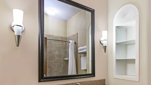 A bathroom with a granite countertop sink, a large mirror, and a towel rack with two white towels. - Holiday Inn Express Hotel & Suites Victoria by IHG (Victoria)