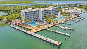 A hotel with a pool, docked boats, and a view of the water. - Anchorage Resort & Yacht Club (Key Largo)