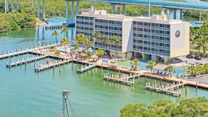 A hotel with a pool area, dock, and a view of a bridge over water. - Anchorage Resort & Yacht Club (Key Largo)