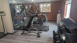 A gym with treadmills, elliptical machines, and a piano. - Candlewood Suites Wilson by IHG (Wilson)
