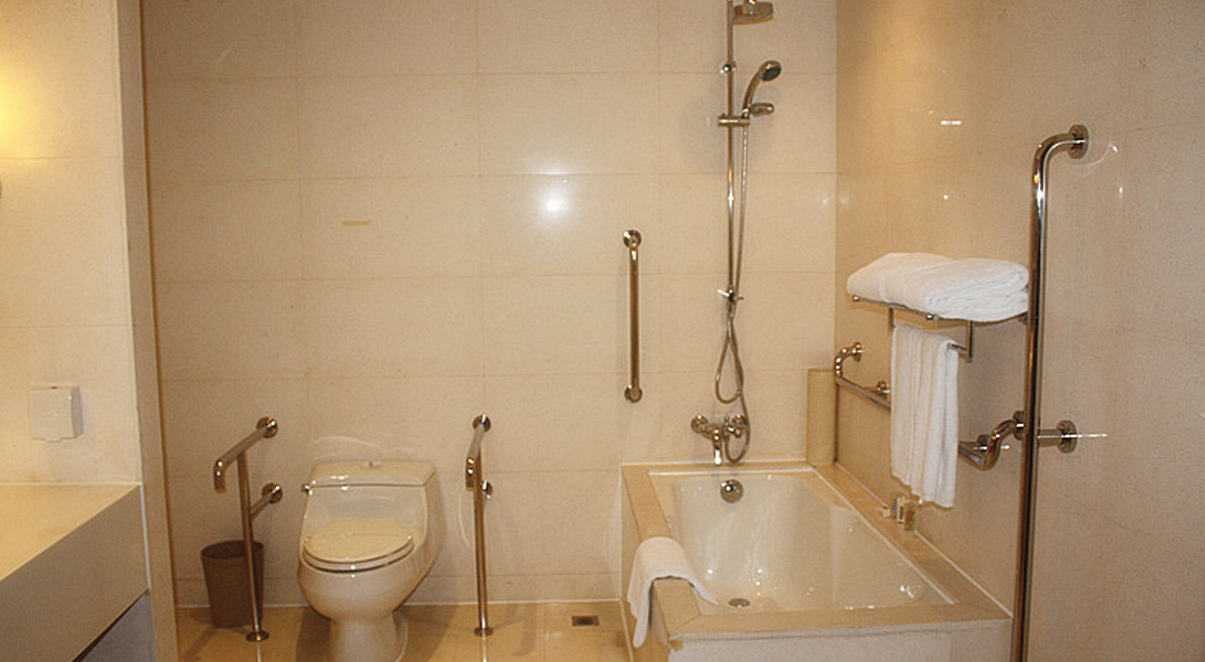 A bathroom with a toilet, a bathtub, and a shower.