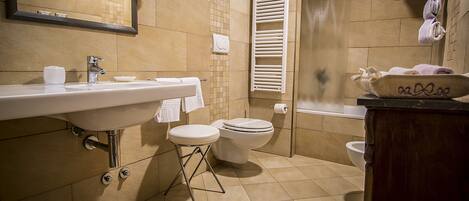 A bathroom with a sink, toilet, and bathtub.