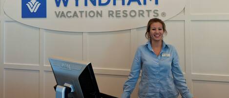 A reception desk at Wyndham Vacation Resorts with a computer and a name tag.