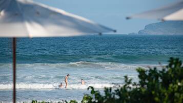 Perto da praia, guarda-sóis, toalhas de praia