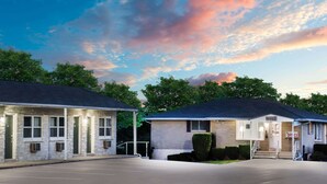 A motel with two buildings, each with a separate entrance and a parking lot in front. - Knights Inn Pine Grove (Pine Grove)