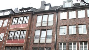 A row of red brick buildings with multiple windows and balconies. - TM Hotel Düsseldorf (Düsseldorf)
