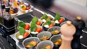 A buffet setup with various food items and condiments. - Orangerie (Düsseldorf)