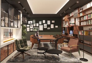 Una biblioteca moderna con una mesa central, estanterías y obras de arte en las paredes.