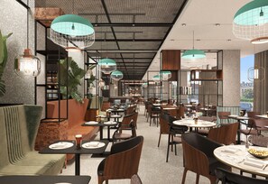A restaurant interior with multiple seating areas, including booths and tables, and hanging pendant lights. - Four Points by Sheraton Poznan (Poznan)