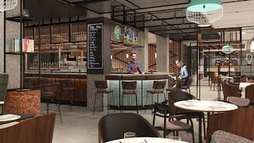 A modern bar area with a bartender, bar stools, and a menu board.