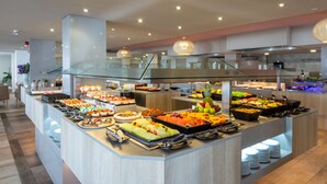 A buffet with various food items and a modern interior design. - Marins Playa (Son Servera)