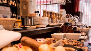 A buffet setup with various food items and serving utensils. - Adina Apartment Hotel Berlin CheckPoint Charlie (Berlin)