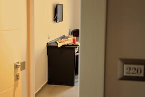 Enter a cozy room with a door marked 220, featuring a convenient breakfast table and a flat-screen TV.